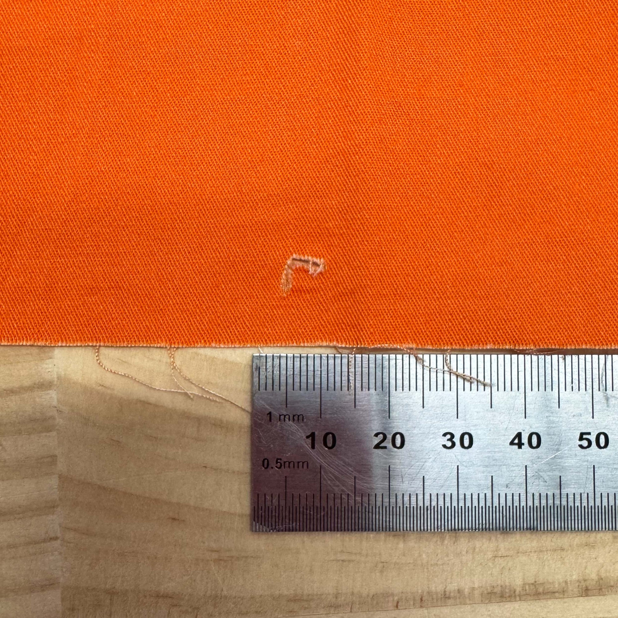 Orange - 1m - Cotton Woven - FAULTS fabric by The Colour Collab mock up on fabric bolt