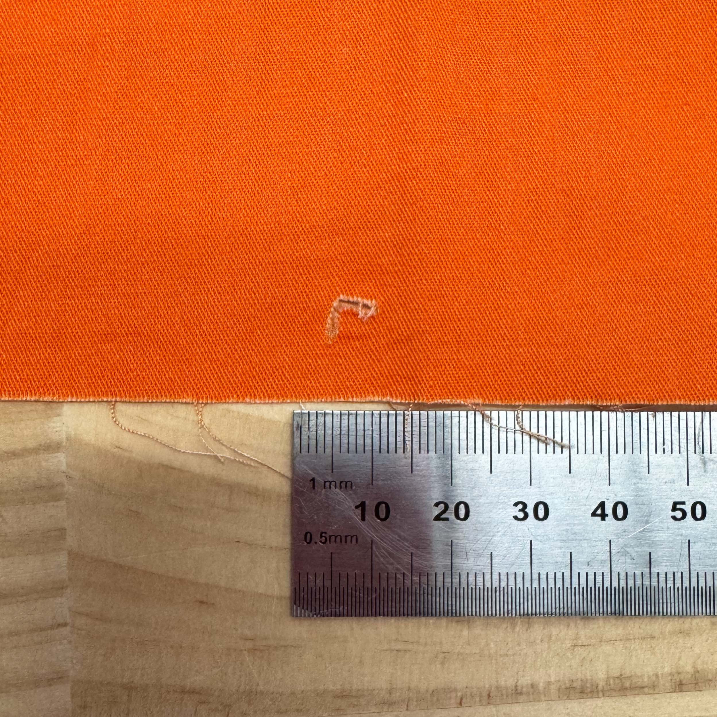 Orange - 1m - Cotton Woven - FAULTS fabric by The Colour Collab mock up on fabric bolt