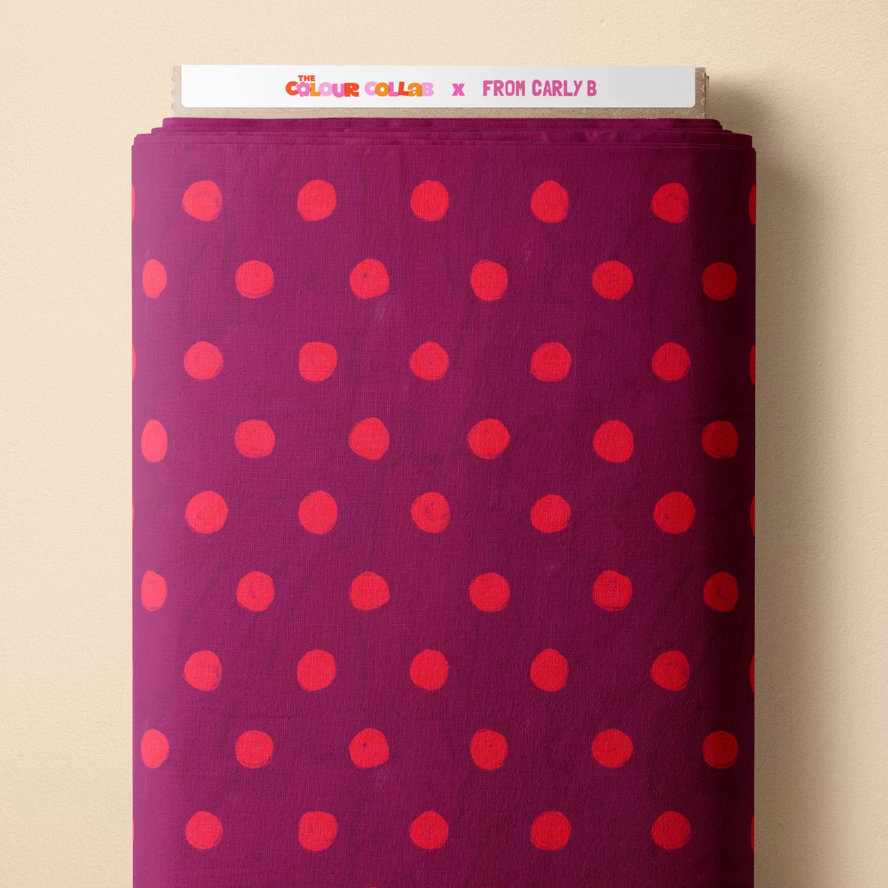 Teeny Tiny Polka Dots (Ribbon & Watermelon) fabric by Carly B mock up on fabric bolt